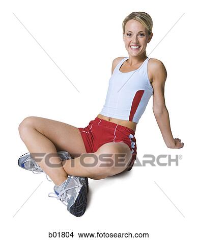Portrait of a young woman sitting on the floor View Large Photo Image Picture - Portrait of a young woman sitting on the floor. Fotosearch