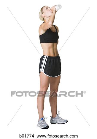 Picture - Profile of a young woman drinking water. Fotosearch