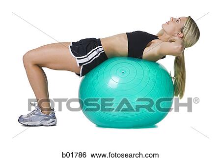 Profile of a young woman lying on a fitness ball View Large Photo Image Stock Photograph - Profile of a young woman lying on a fitness ball. Fotosearch