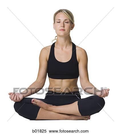 Stock Photography - Young woman doing yoga with her legs crossed. Fotosearch