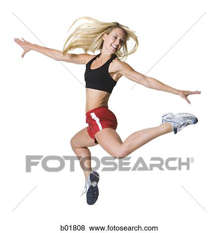 Young woman jumping with her arms outstretched View Large Photo Image Stock Photo - Young woman jumping with her arms outstretched. Fotosearch