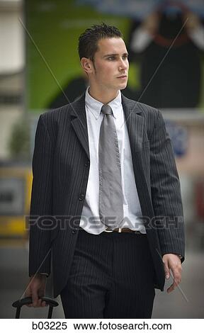 Stock Photography - Businessman pulling his luggage. Fotosearch