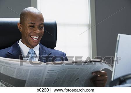 Businessman reading a newspaper View Large Photo Image Stock Image - Businessman reading a newspaper. Fotosearch