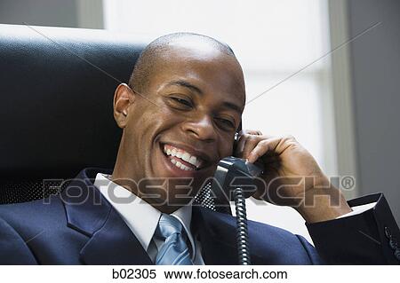 Businessman talking on the telephone View Large Photo Image Stock Photography - Businessman talking on the telephone. Fotosearch