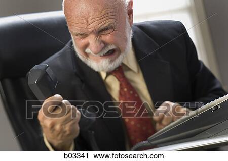 Close-up of a businessman holding a telephone receiver View Large Photo Image Stock Image - Close-up of a businessman holding a telephone receiver. Fotosearch