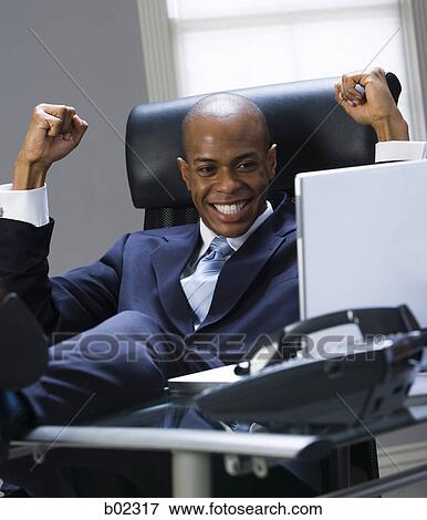 Close-up of a businessman smiling and clenching fists View Large Photo Image Stock Photo - Close-up of a businessman smiling and clenching fists. Fotosearch