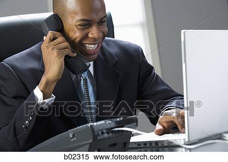 Close-up of a businessman smiling and talking on the phone View Large Photo Image Stock Photography - Close-up of a businessman smiling and talking on the phone. Fotosearch