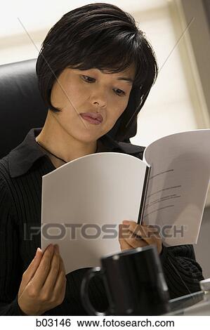 Close-up of a businesswoman reading a book View Large Photo Image Stock Photograph - Close-up of a businesswoman reading a book. Fotosearch