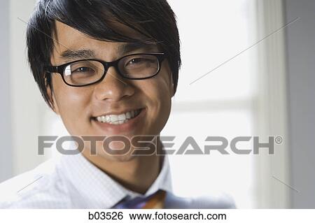 Stock Photograph - High angle view of a young man standing. Fotosearch