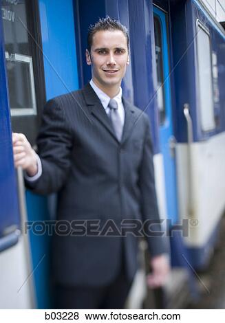 Portrait of a businessman holding the door handle of a train View Large Photo Image Stock Photo - Portrait of a businessman holding the door handle of a train. Fotosearch
