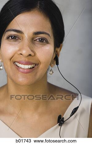 Portrait of a businesswoman wearing a hands free device View Large Photo Image Stock Image - Portrait of a businesswoman wearing a hands free device. Fotosearch
