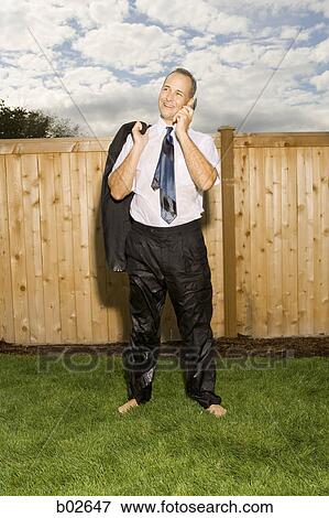 Businessman talking on a mobile phone View Large Photo Image Stock Photo - Businessman talking on a mobile phone. Fotosearch