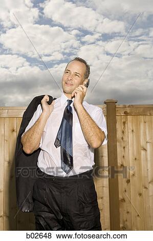 Businessman talking on a mobile phone View Large Photo Image Stock Photo - Businessman talking on a mobile phone. Fotosearch