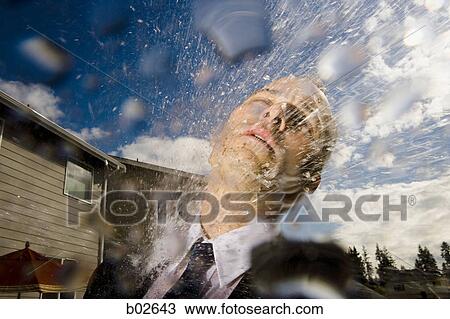 Close-up of a businessman getting hosed View Large Photo Image Stock Image - Close-up of a businessman getting hosed. Fotosearch