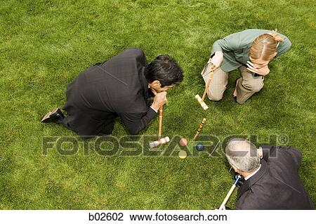 High angle view of two businessmen and a businesswoman playing croquet View Large Photo Image Stock Image - High angle view of two businessmen and a businesswoman playing croquet. Fotosearch