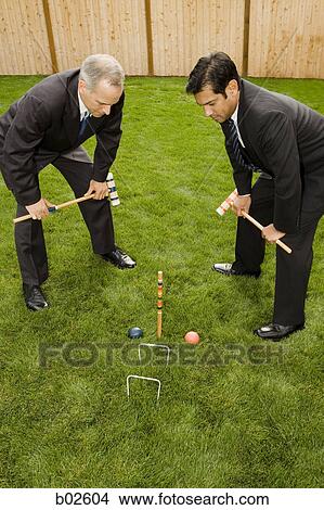 High angle view of two businessmen playing croquet View Large Photo Image Picture - High angle view of two businessmen playing croquet. Fotosearch