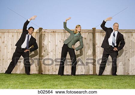 Low angle view of two businessmen and a businesswoman exercising View Large Photo Image Picture - Low angle view of two businessmen and a businesswoman exercising. Fotosearch
