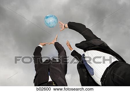 Low angle view of two businessmen playing with a ball View Large Photo Image Stock Image - Low angle view of two businessmen playing with a ball. Fotosearch