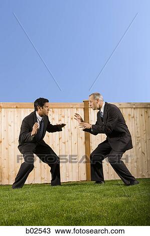 Profile of two businessmen playing and rough housing View Large Photo Image Stock Image - Profile of two businessmen playing and rough housing. Fotosearch