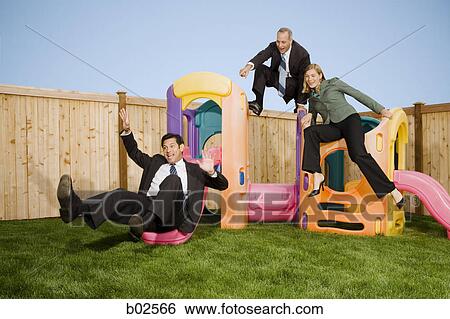 Stock Photograph - Two businessmen and a businesswoman playing with jungle gym. Fotosearch