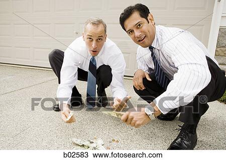 Two businessmen gambling on the street View Large Photo Image Stock Image - Two businessmen gambling on the street. Fotosearch
