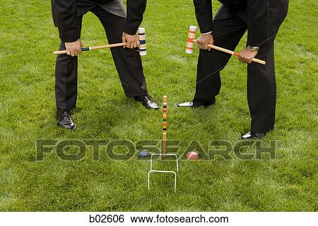 Two businessmen playing croquet View Large Photo Image Stock Photograph - Two businessmen playing croquet. Fotosearch