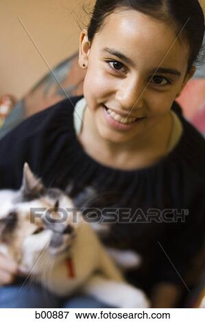 Stock Photo - Close-up of a girl holding a cat. Fotosearch