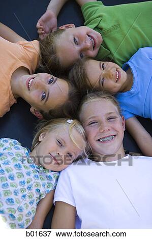 High angle view of five girls lying together View Large Photo Image Stock Photo - High angle view of five girls lying together. Fotosearch