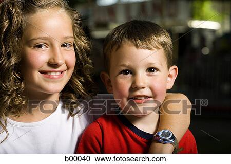 Stock Image - Portrait of a boy and a girl smiling. Fotosearch