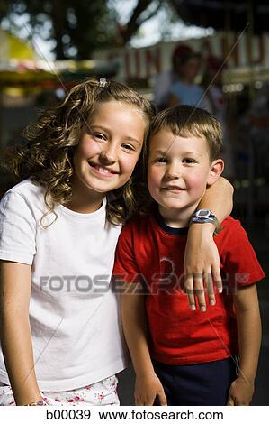 Portrait of a boy and a girl smiling View Large Photo Image Stock Photo - Portrait of a boy and a girl smiling. Fotosearch