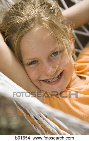 Portrait of a girl lying in a hammock View Large Photo Image Picture - Portrait of a girl lying in a hammock. Fotosearch