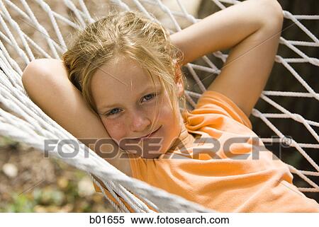 Stock Photography - Portrait of a girl lying in a hammock. Fotosearch
