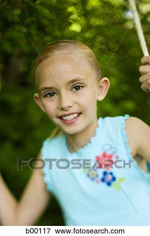 Portrait of a girl swinging on a swing View Large Photo Image Stock Photo - Portrait of a girl swinging on a swing. Fotosearch