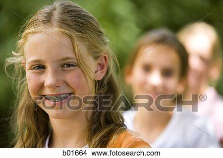 Picture - Portrait of three girls sitting. Fotosearch