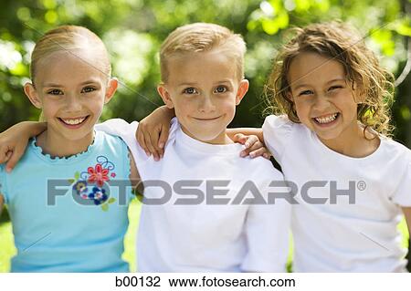Portrait of two girls and a boy standing with their arms around View Large Photo Image Stock Image - Portrait of two girls and a boy standing with their arms around. Fotosearch