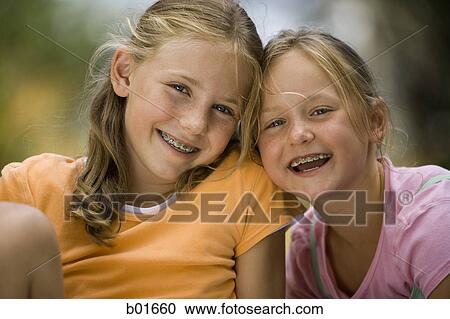 Portrait of two girls smiling View Large Photo Image Stock Image - Portrait of two girls smiling. Fotosearch