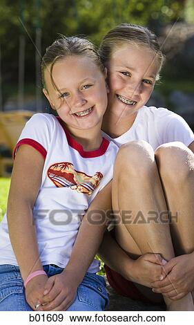 Portrait of two girls smiling View Large Photo Image Stock Photo - Portrait of two girls smiling. Fotosearch