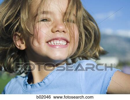 Close-up of a girl smiling View Large Photo Image Stock Photograph - Close-up of a girl smiling. Fotosearch