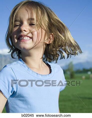 Close-up of a girl smiling View Large Photo Image Stock Photography - Close-up of a girl smiling. Fotosearch
