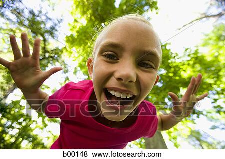 Low angle view of a girl laughing View Large Photo Image Stock Photo - Low angle view of a girl laughing. Fotosearch