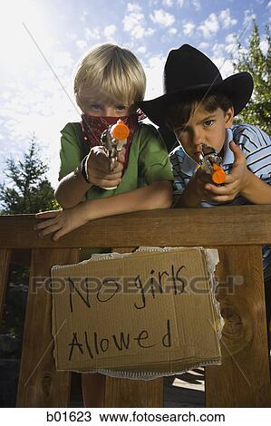 Low angle view of two boys dressed as cops and robbers View Large Photo Image Stock Image - Low angle view of two boys dressed as cops and robbers. Fotosearch