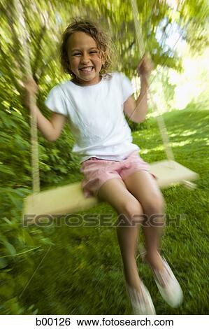 Portrait of a girl sitting on a swing View Large Photo Image Stock Photograph - Portrait of a girl sitting on a swing. Fotosearch