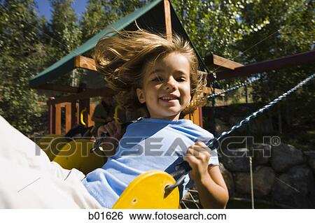 Portrait of a girl sitting on a swing View Large Photo Image Stock Photograph - Portrait of a girl sitting on a swing. Fotosearch