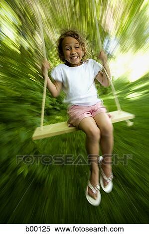 Portrait of a girl swinging on a swing View Large Photo Image Stock Photography - Portrait of a girl swinging on a swing. Fotosearch