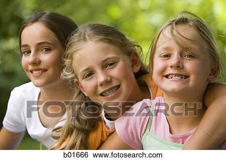 Portrait of three girls sitting together View Large Photo Image Stock Photograph - Portrait of three girls sitting together. Fotosearch