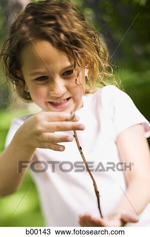 Stock Image - Girl holding an earthworm. Fotosearch