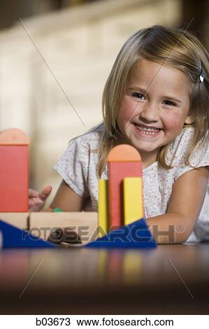 Stock Image - High angle view of a young man reading a book in a hammock. Fotosearch