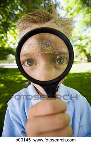 Portrait of a boy looking through a magnifying glass View Large Photo Image Stock Photography - Portrait of a boy looking through a magnifying glass. Fotosearch