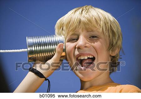 Portrait of a boy using a tin can phone View Large Photo Image Stock Photography - Portrait of a boy using a tin can phone. Fotosearch
