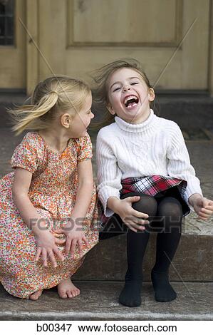 Two sisters sitting in a porch and laughing View Large Photo Image Stock Photo - Two sisters sitting in a porch and laughing. Fotosearch
